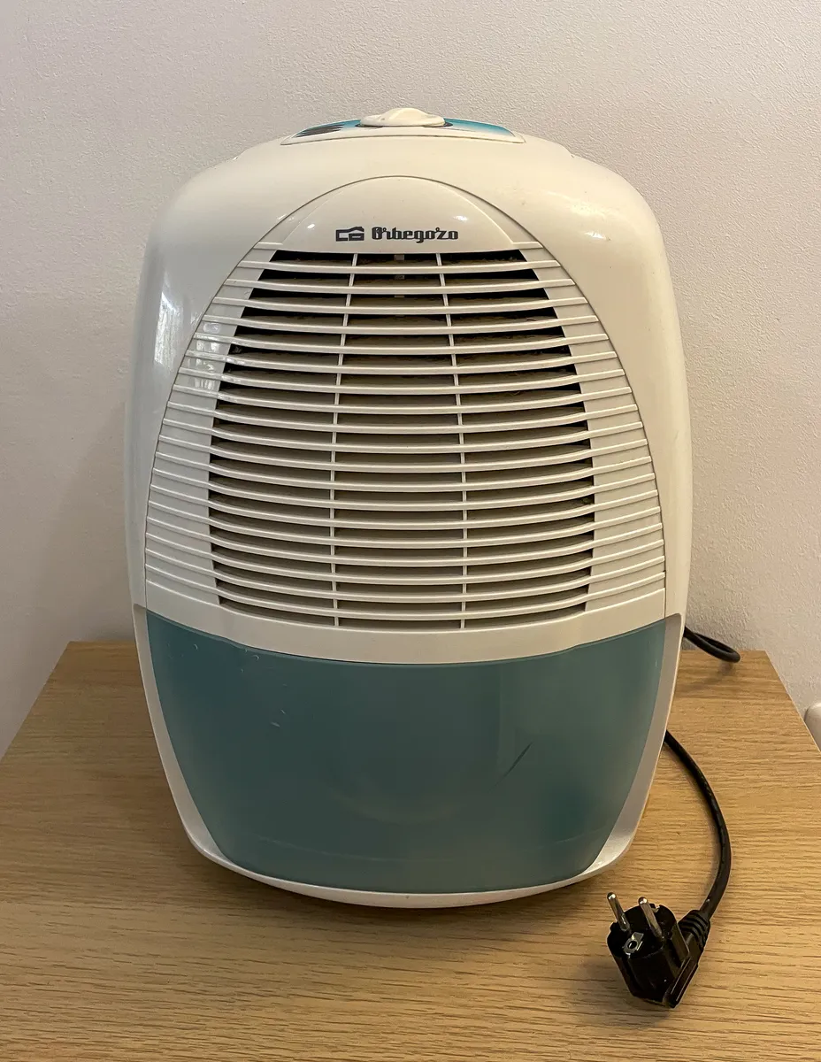 A portable air dehumidifier with its power cable