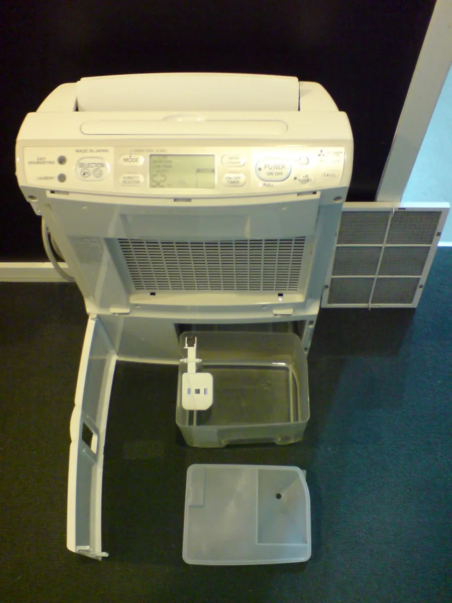 A dehumidifier partly disassembled showing the coil and internal parts