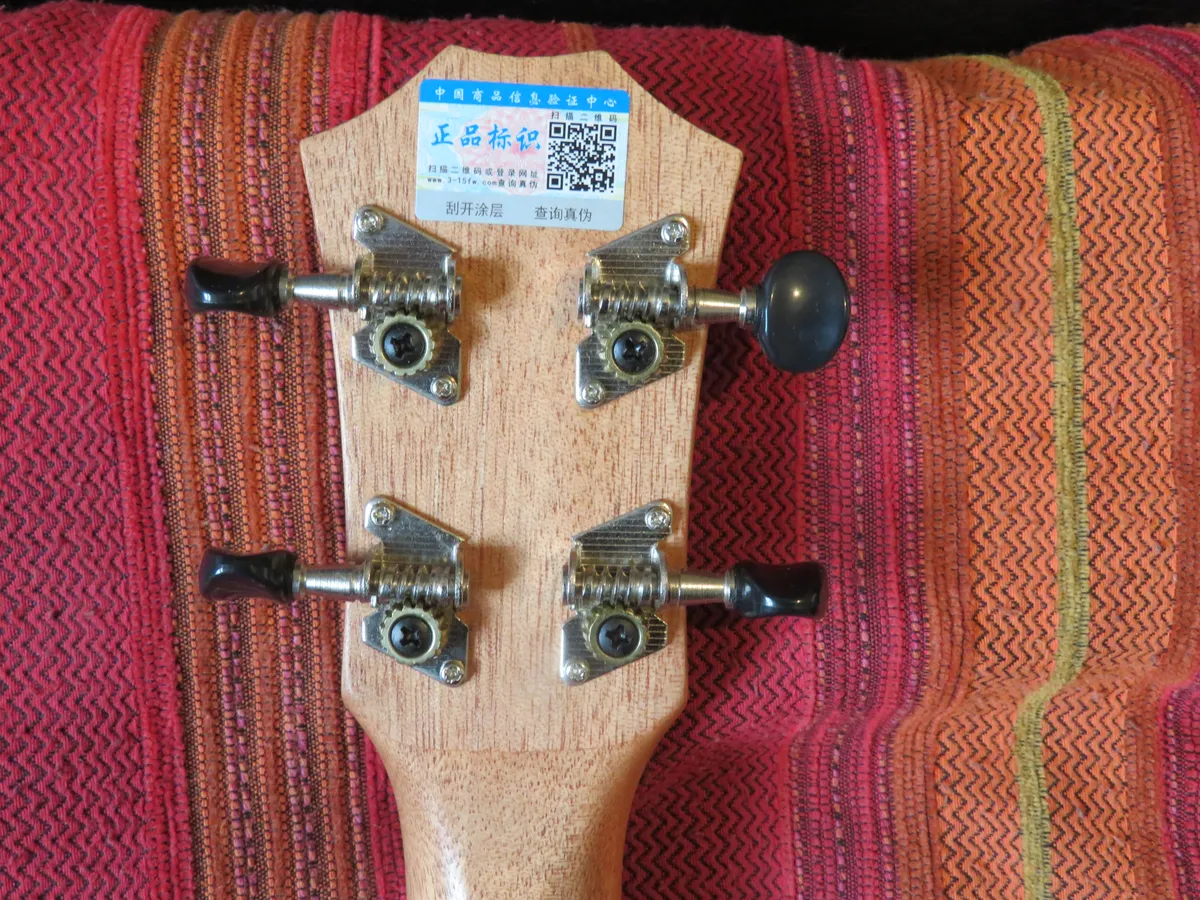 Ukulele headstock with open gear tuning machines