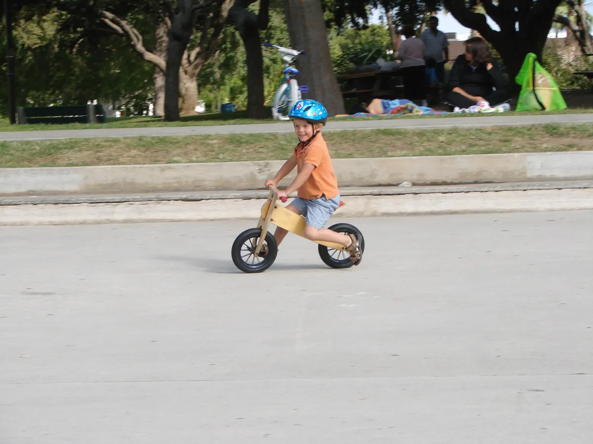 Balance bike shown from the side, demonstrating the absence of pedals and chain