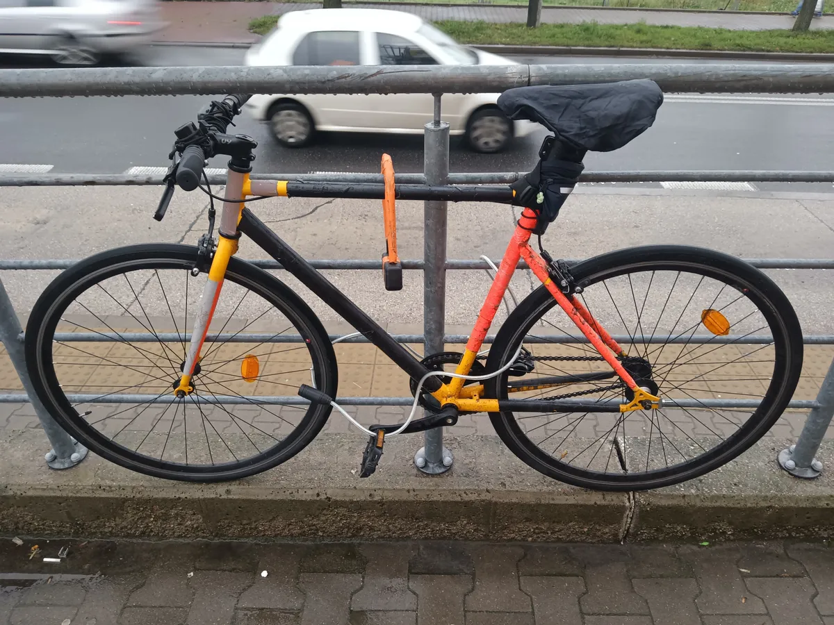 City bike locked with a U-lock and a supplementary steel cable through the wheels