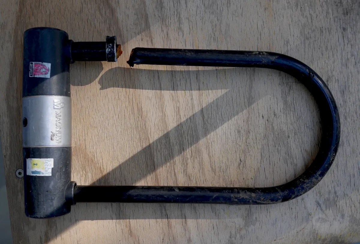 A U-lock shackle that has been severed, illustrating how these locks fail