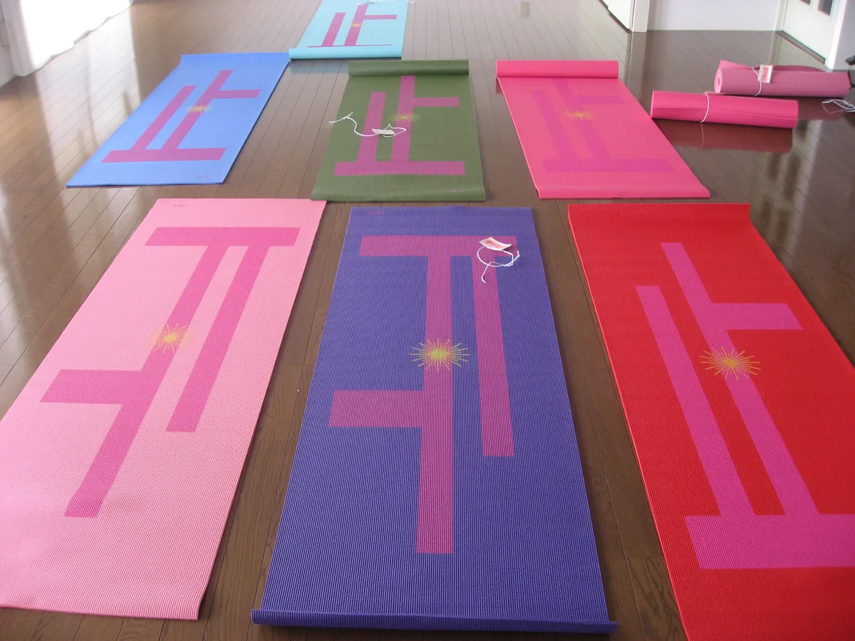 Rolled yoga mats stored upright