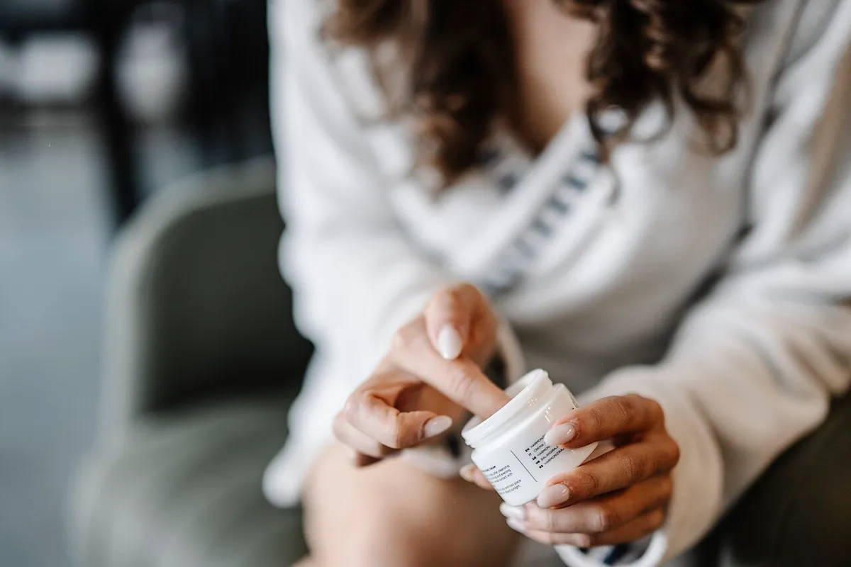 Applying face cream as part of a daily skincare routine