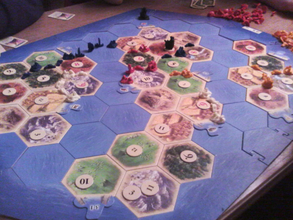 Catan board mid-game with hexagonal resource tiles and number tokens