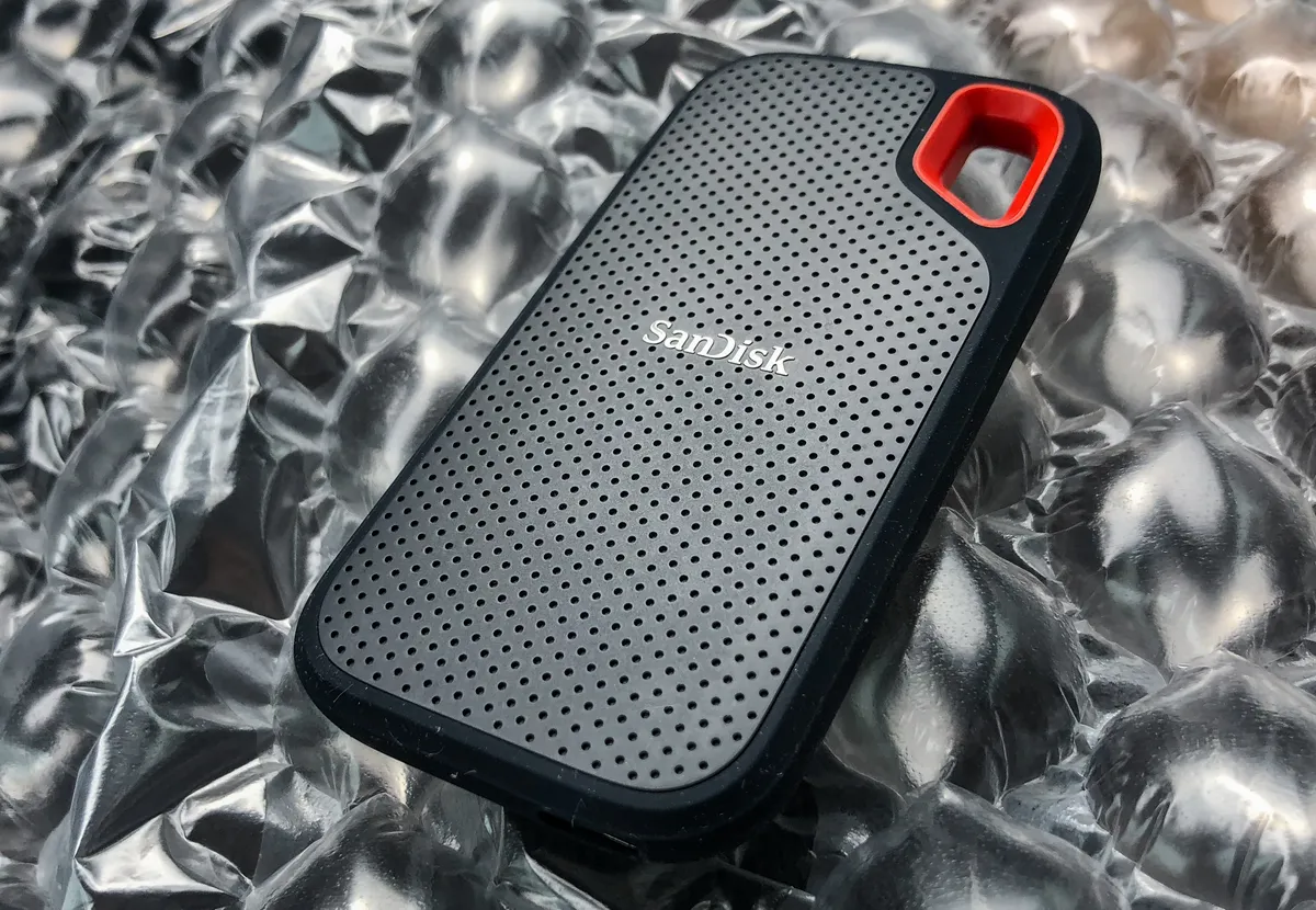 A rugged-style portable SSD with a rubberised body, shown for comparison