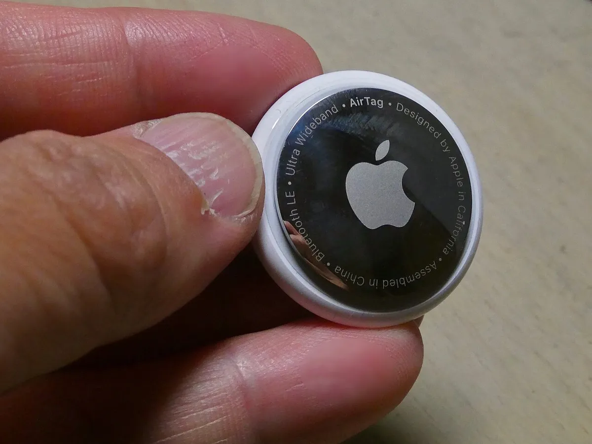 Back of an Apple AirTag showing the battery compartment