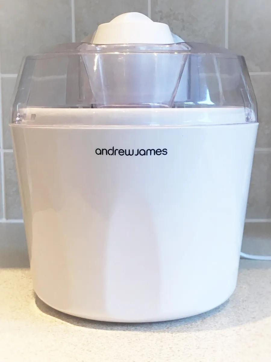 A compact electric home ice cream maker on a kitchen counter