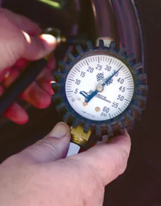 Handheld tire pressure gauge measuring PSI
