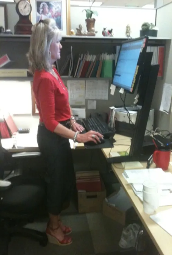 Illustration of a sit-stand desk in both seated and standing positions