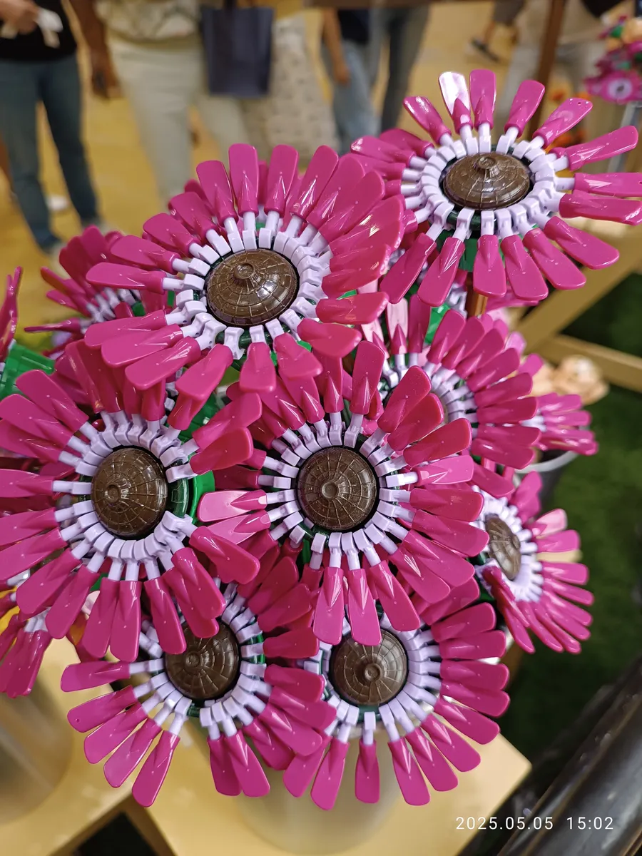 Close-up of a red LEGO flower bloom built from specialty brick pieces