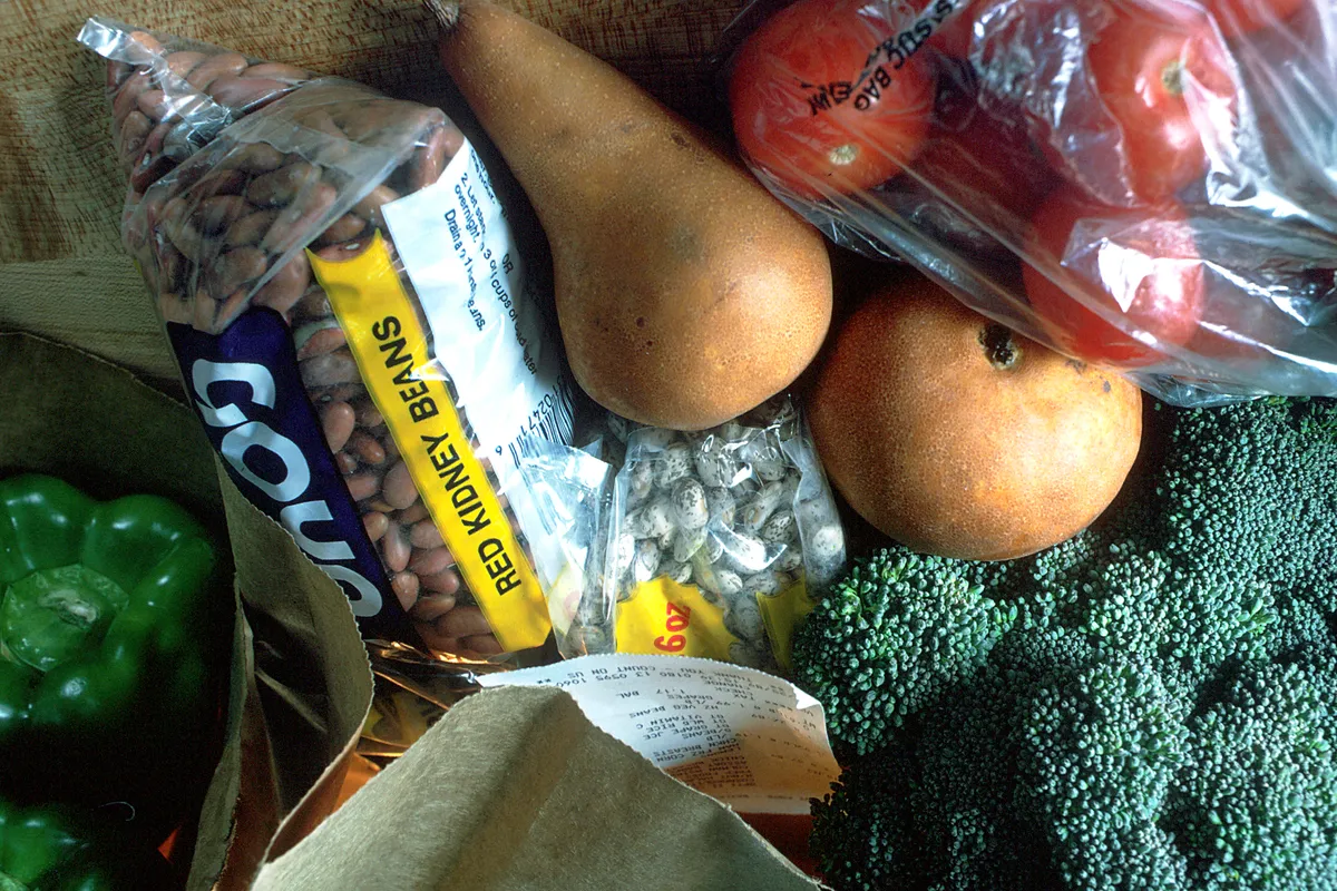 Grocery bag filled with fresh produce and pantry staples