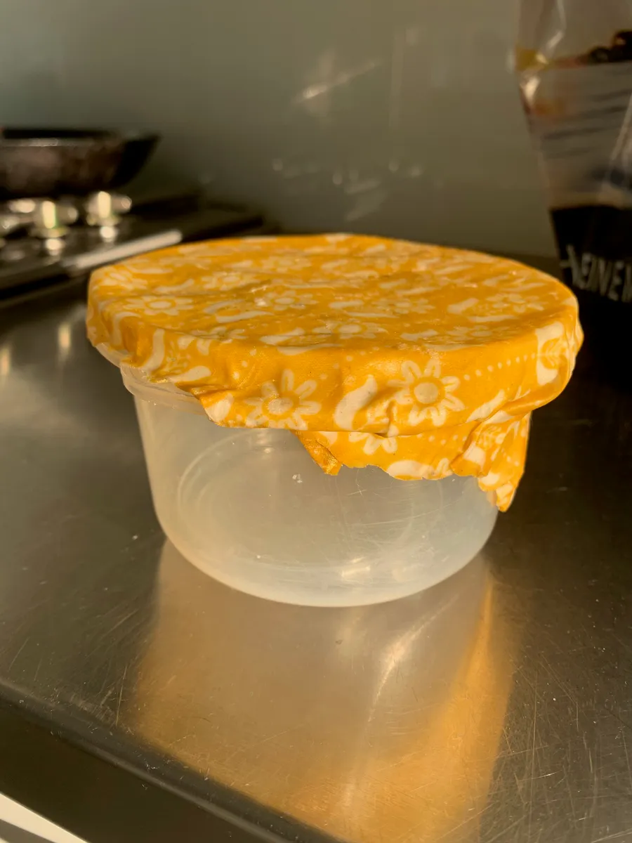 Beeswax wrap covering a bowl of food as a reusable alternative to cling film