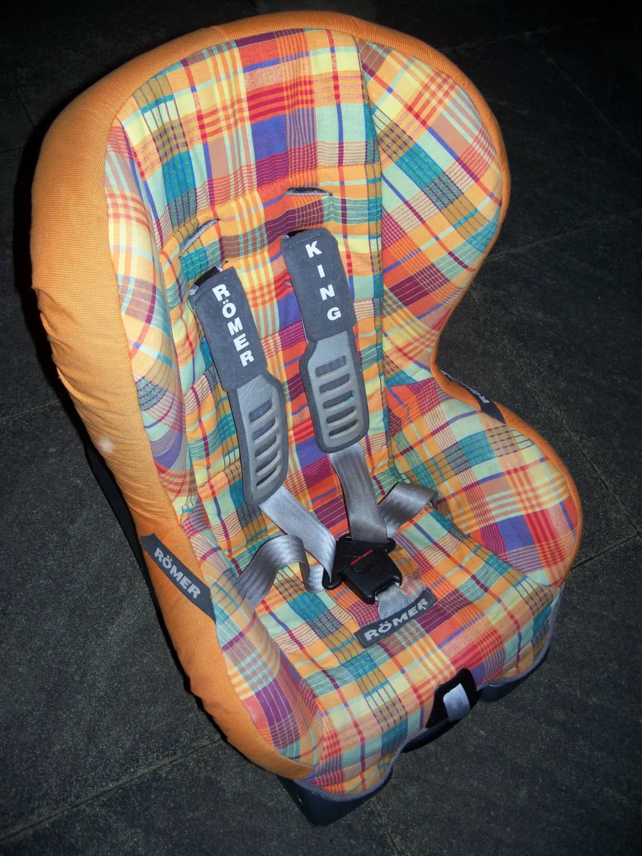 Forward-facing child car seat installed with harness visible