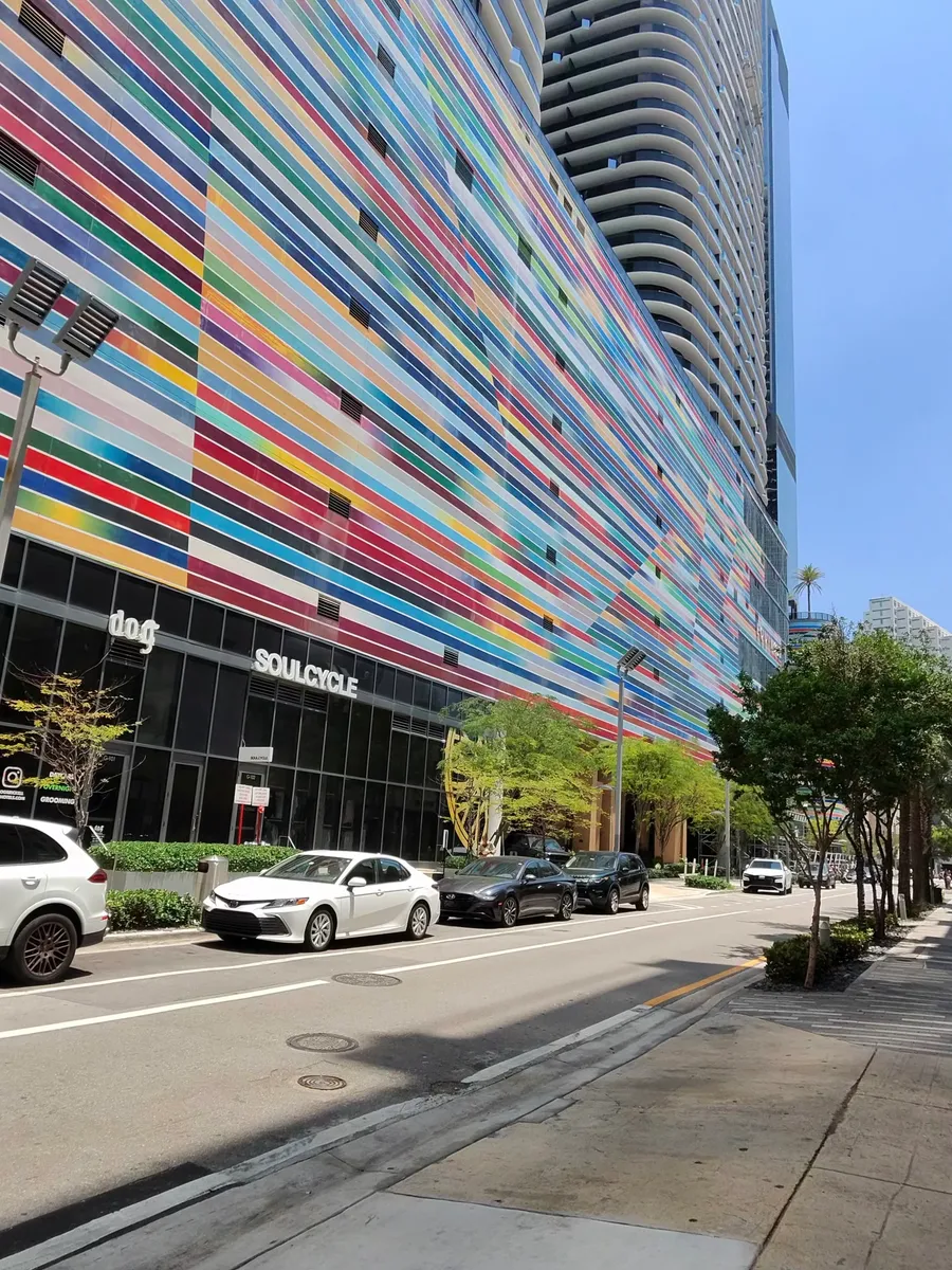 Ray-Ban Meta smart glasses displayed against a colorful building facade