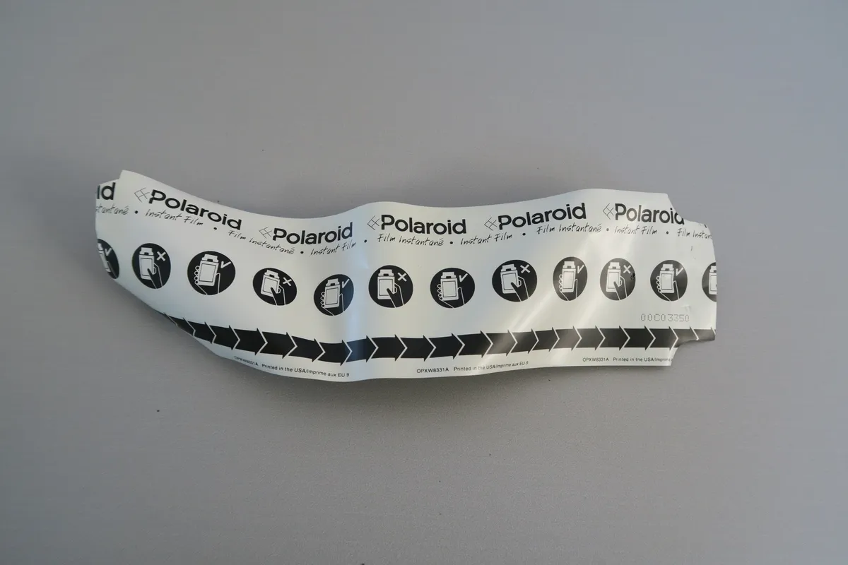 Developed square-format Polaroid instant photograph with classic white border resting on a table