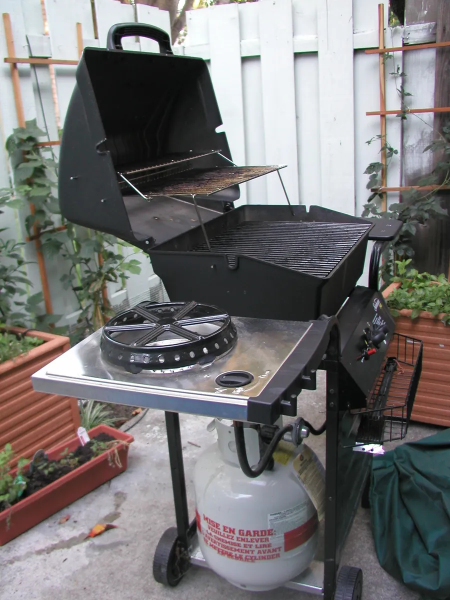 A backyard gas barbecue grill set up on a patio