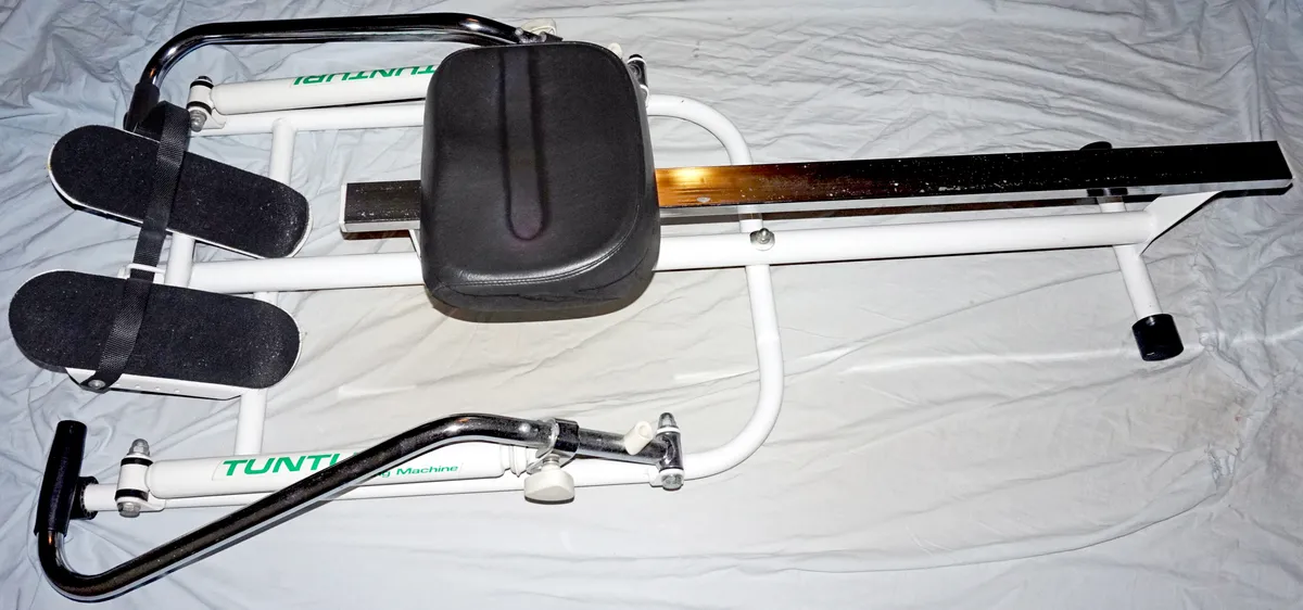 Close-up of a rowing machine seat rail and footplate mechanism