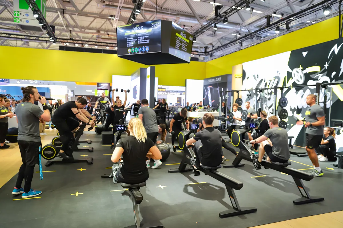 Modern connected indoor rowing machines on display at a fitness trade show