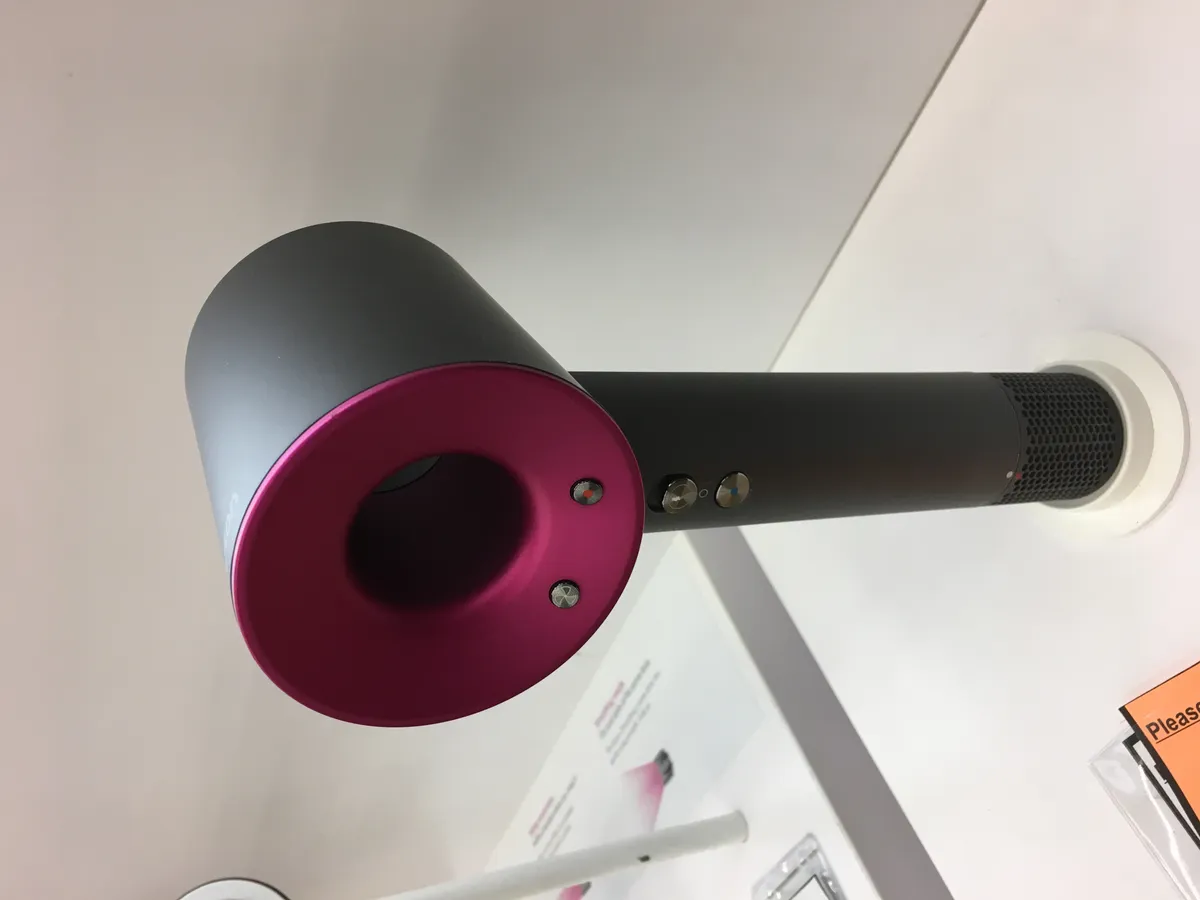 Detail view of a Dyson styling tool's control buttons and finish, representative of the brand's build quality across its hair care lineup
