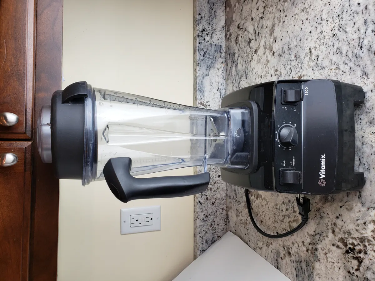 Vitamix 5200 Classic blender with tamper inserted through the lid opening