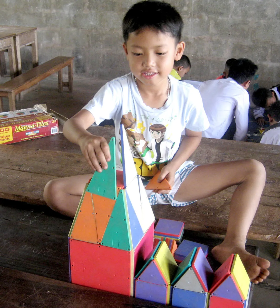 Children playing with Magna-Tiles magnetic building tiles at a community activity day