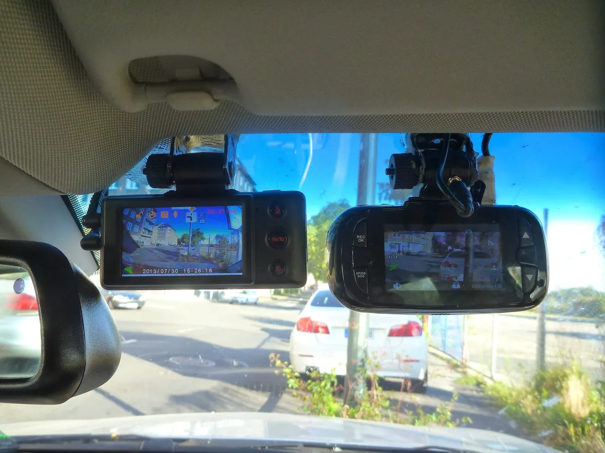 Several dash camera units compared side by side on a table