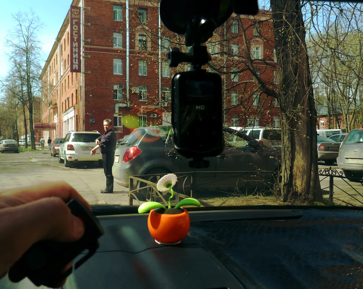 Small dash camera recorder mounted near a car's rearview mirror