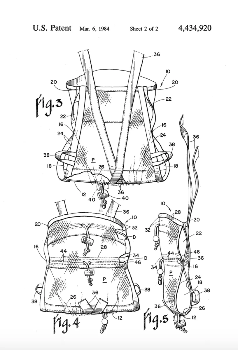 Rear view of a structured baby carrier showing the back-carry configuration and cross-strap design