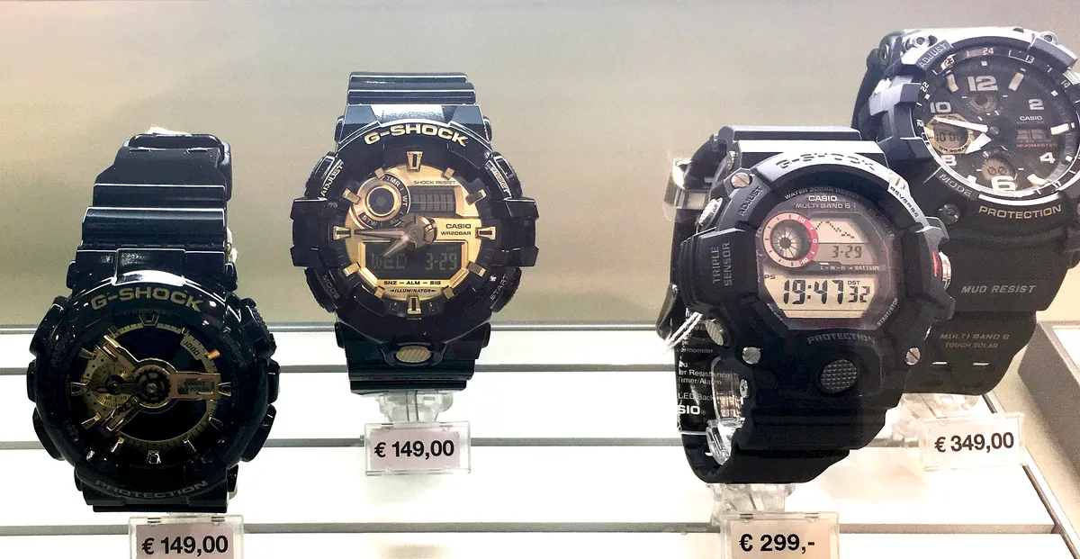Multiple Casio G-Shock watch models displayed in a retail store case