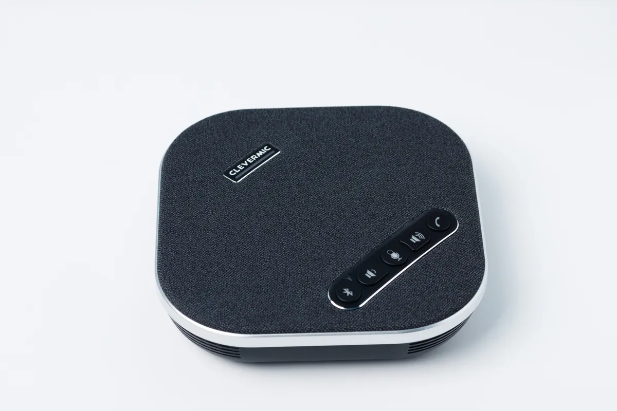 A USB conference speakerphone puck similar in form factor to the Anker PowerConf S3, shown for illustrative comparison