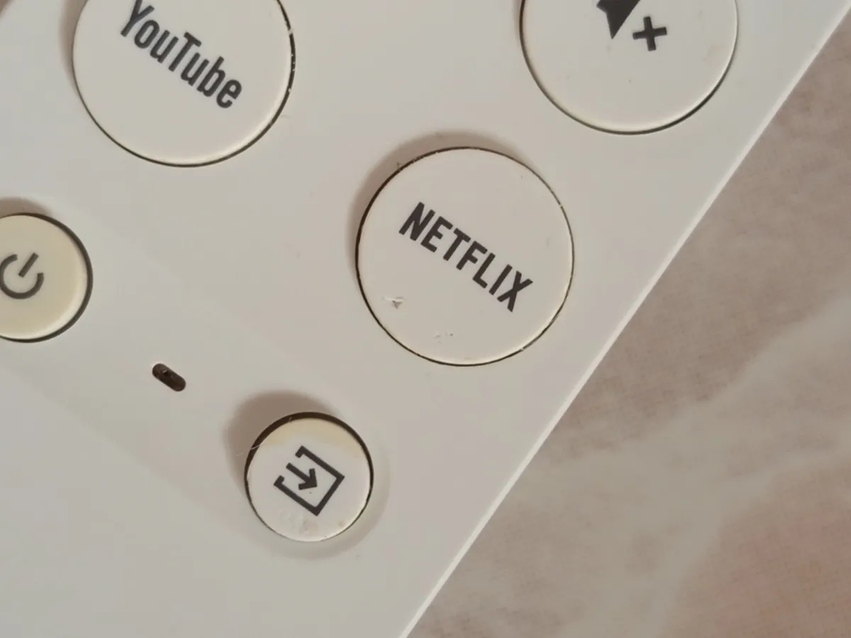 Close-up of the dedicated Netflix shortcut button on the Chromecast with Google TV remote