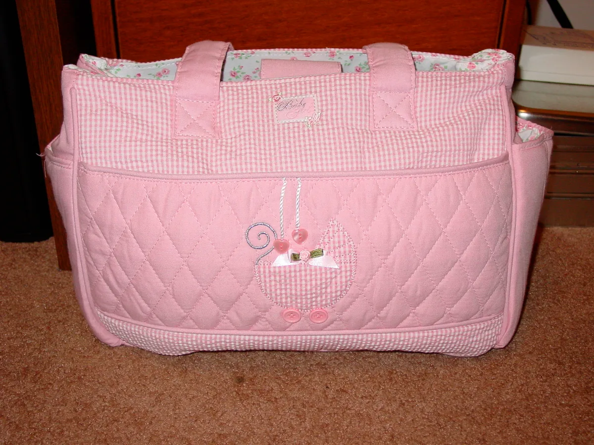 Packed baby bag with visible pockets and compartments for diapers and supplies