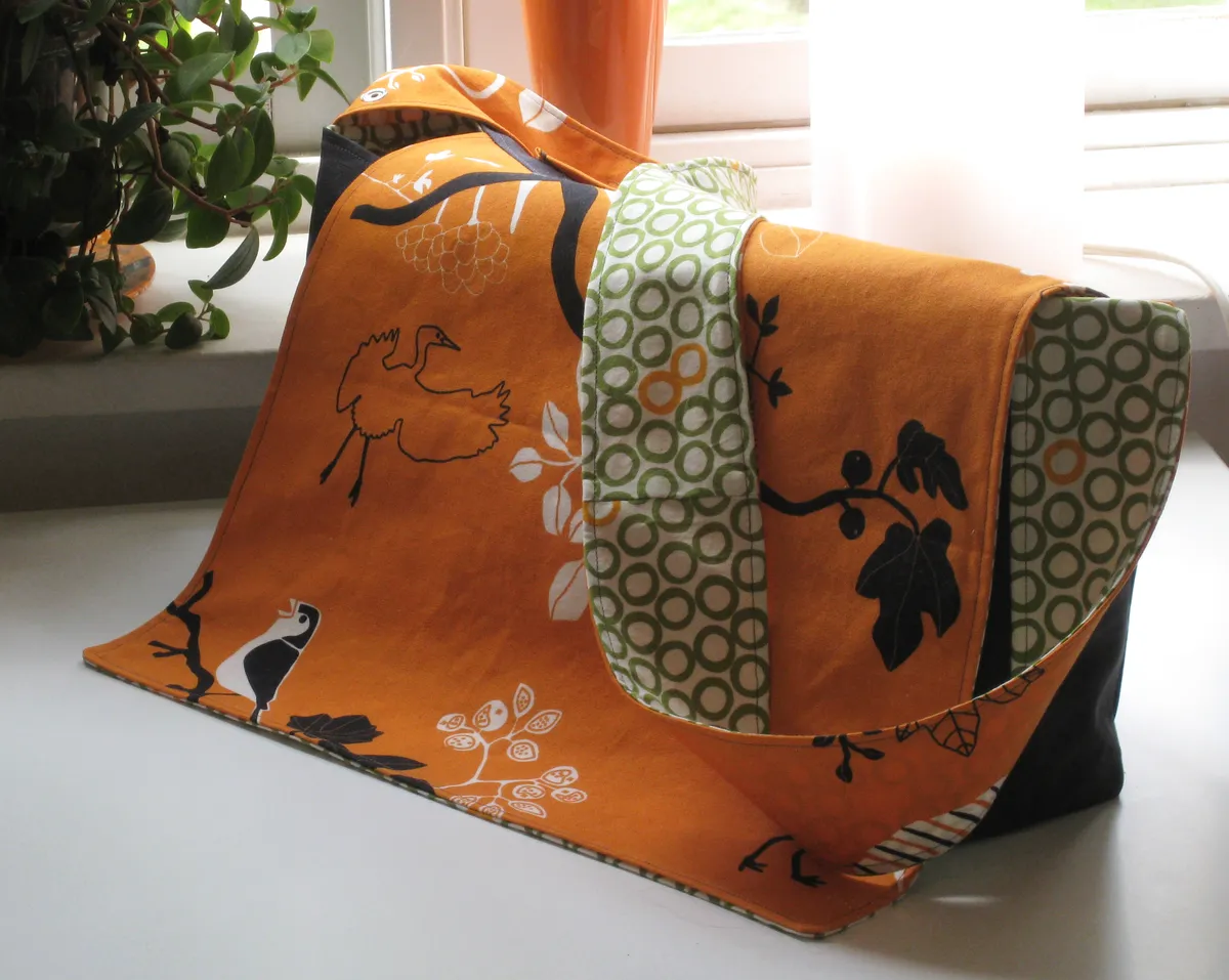 Exterior view of a packed diaper bag with side pockets visible