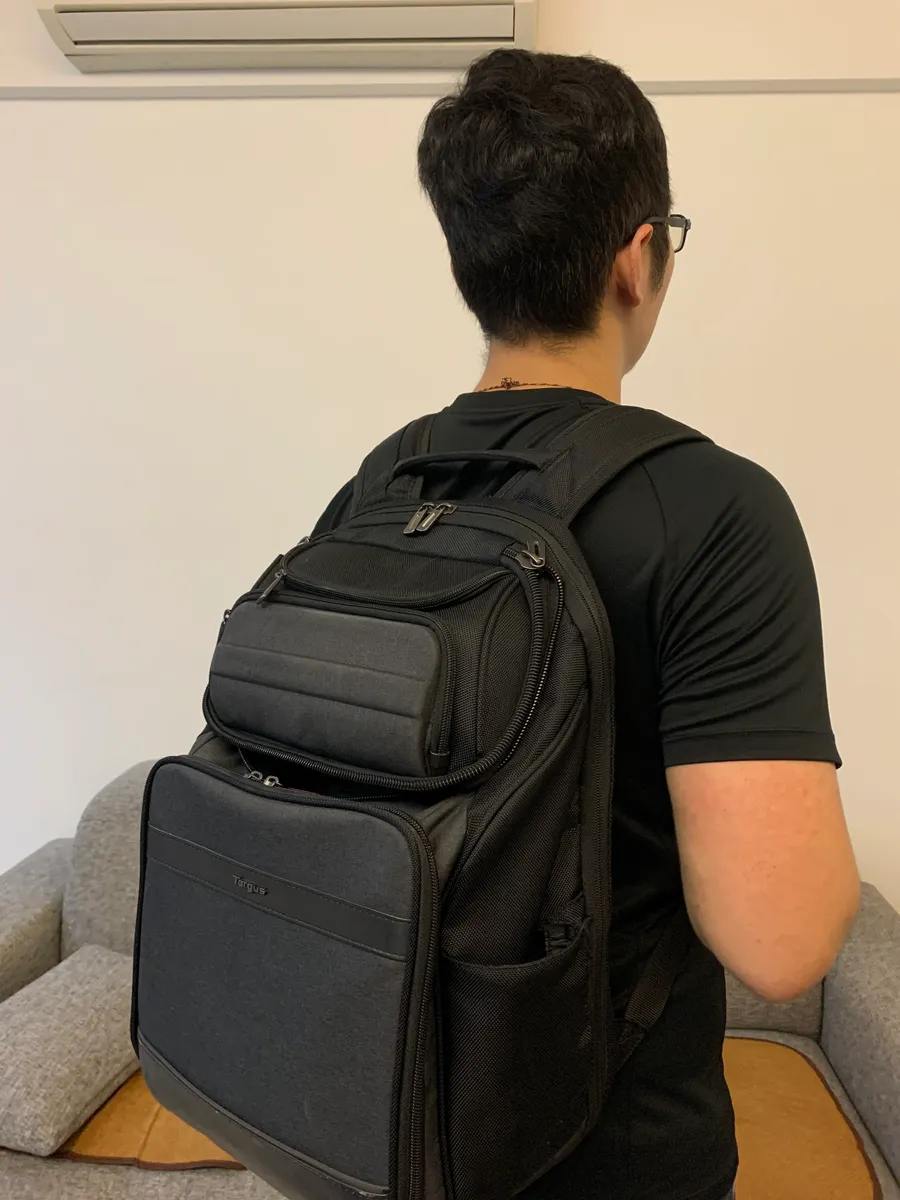 Parent carrying a baby bag, illustrating everyday shared use between caregivers