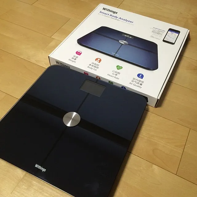 Withings smart body composition scale on a bathroom floor