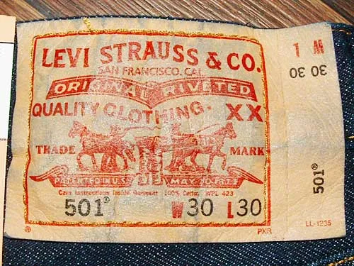 Interior fabric content and care label sewn into a pair of Levi's 501 jeans