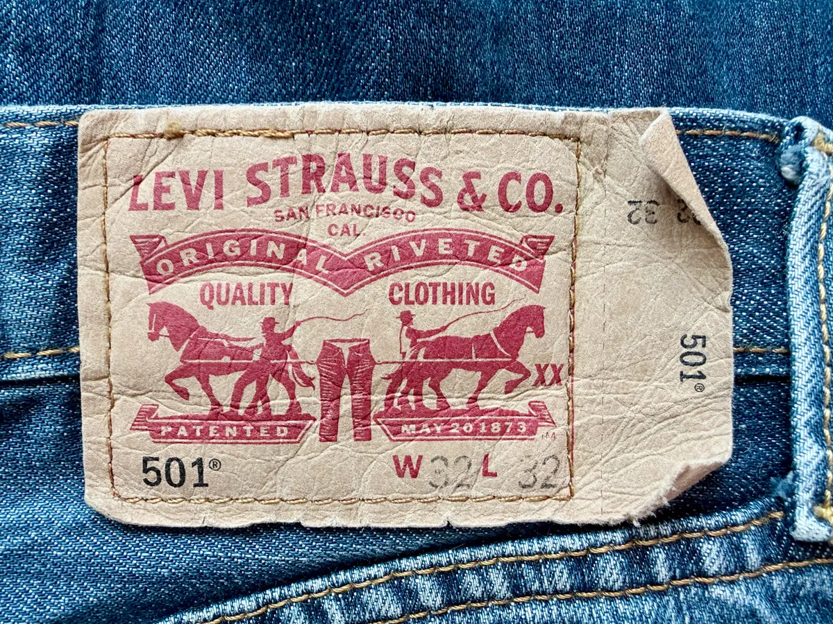 Close-up of the leather Two Horses patch on the waistband of Levi's 501 jeans