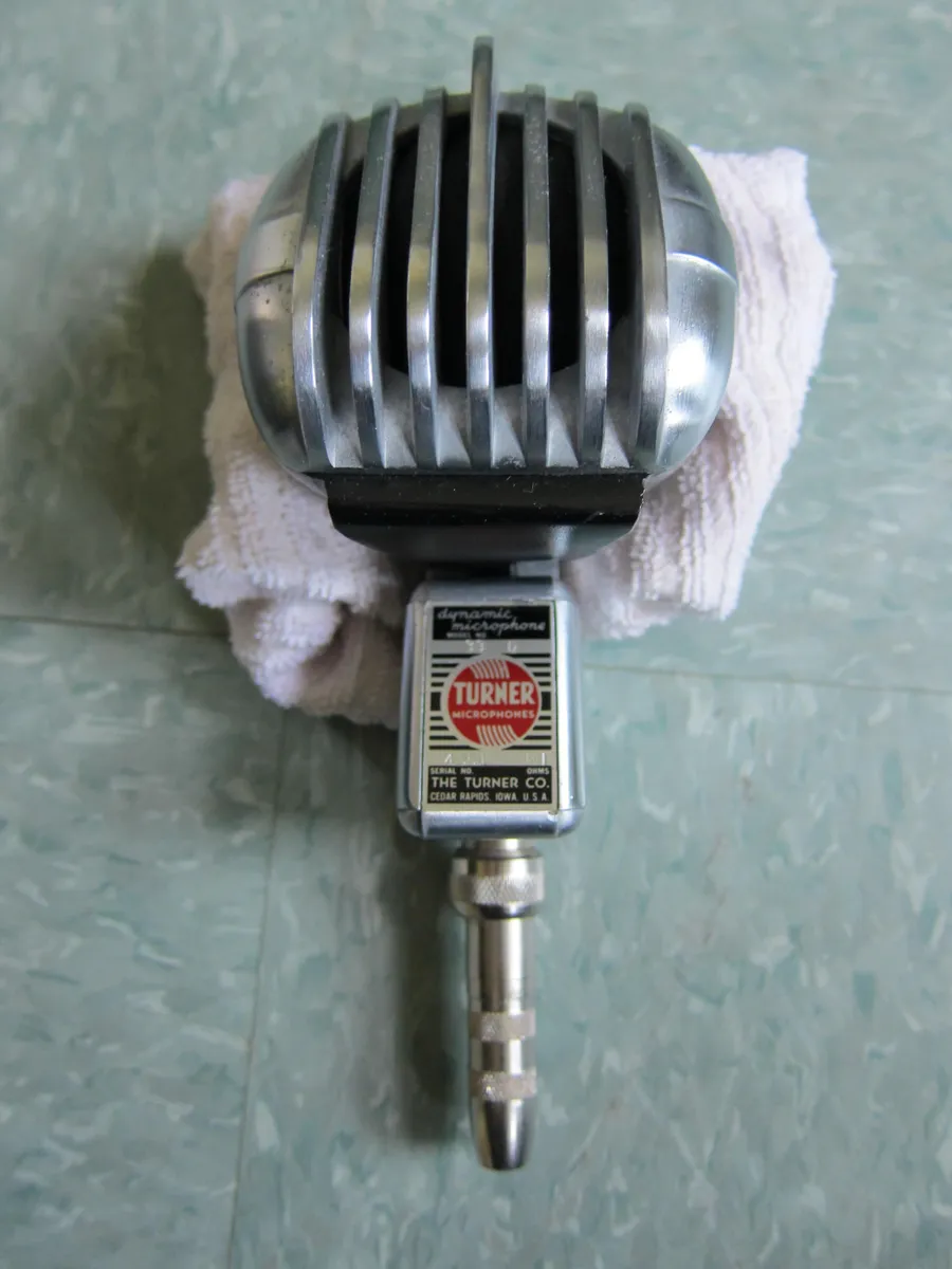 A dynamic microphone on a stand, illustrating typical mounting hardware weight considerations for heavier broadcast mics