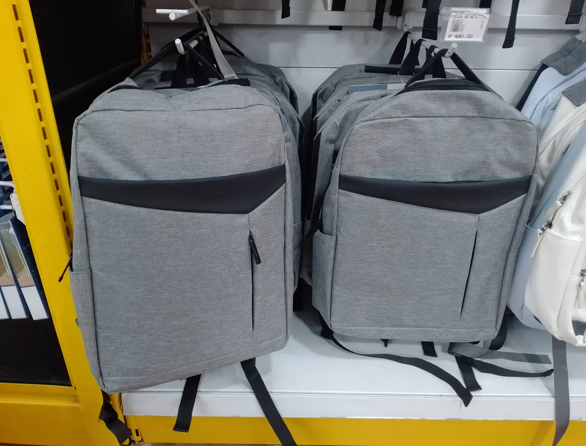 Laptop backpacks displayed on a retail shelf, illustrating the range of laptop-carrying daypacks on the market