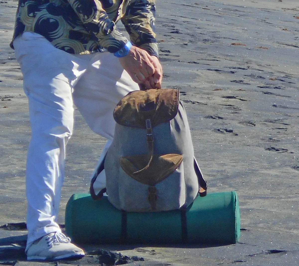 A small, compact backpack shown against a plain background, similar in scale to a compact everyday-carry daypack