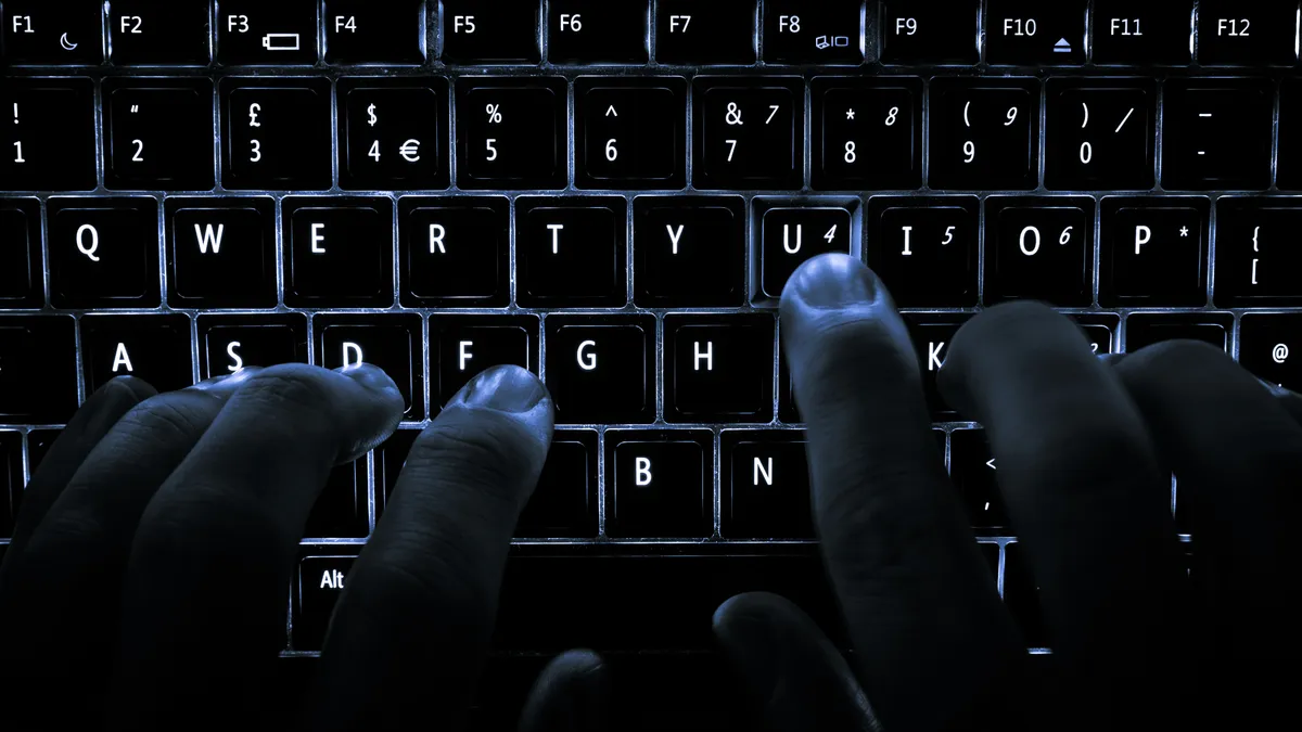 Close-up of a keyboard with white LED backlighting under the keycaps