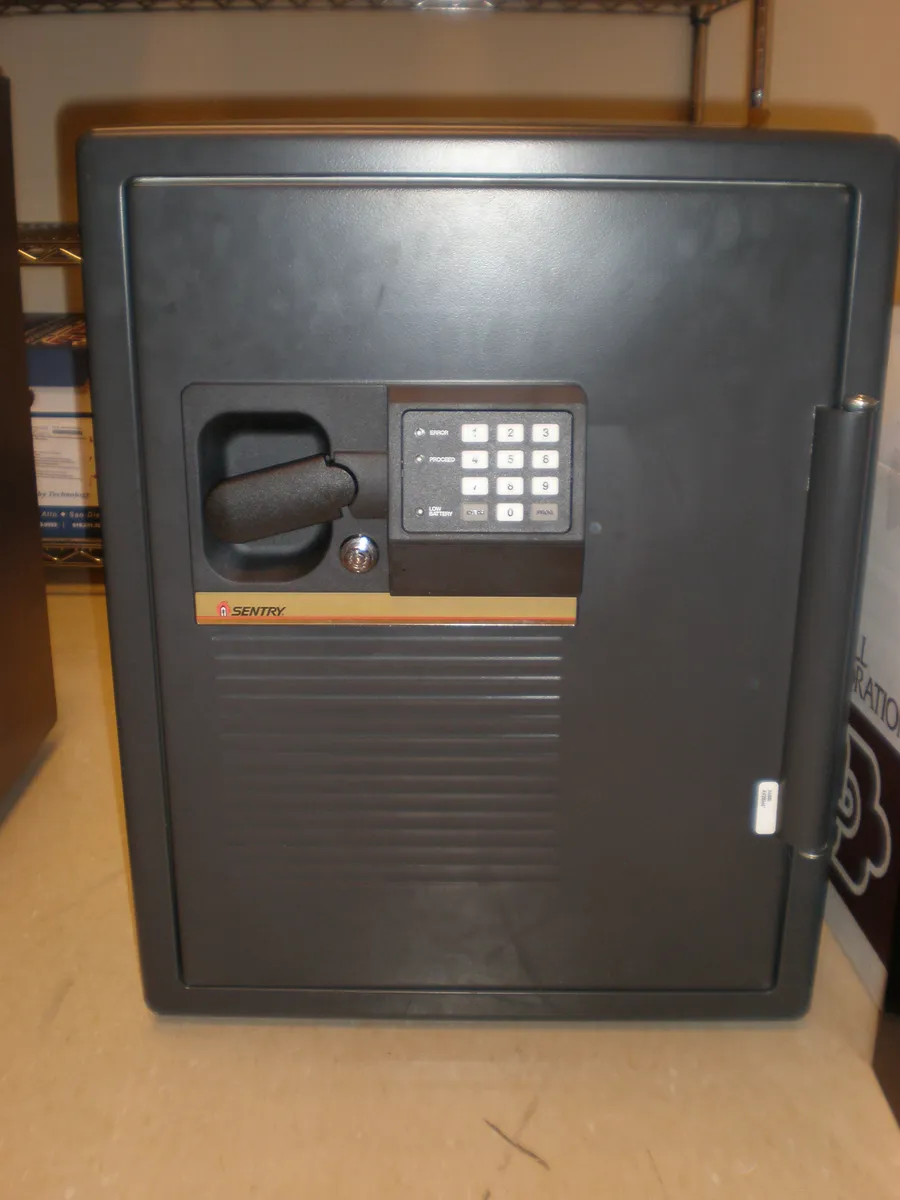Front view of a SentrySafe branded steel fire safe with lever handle