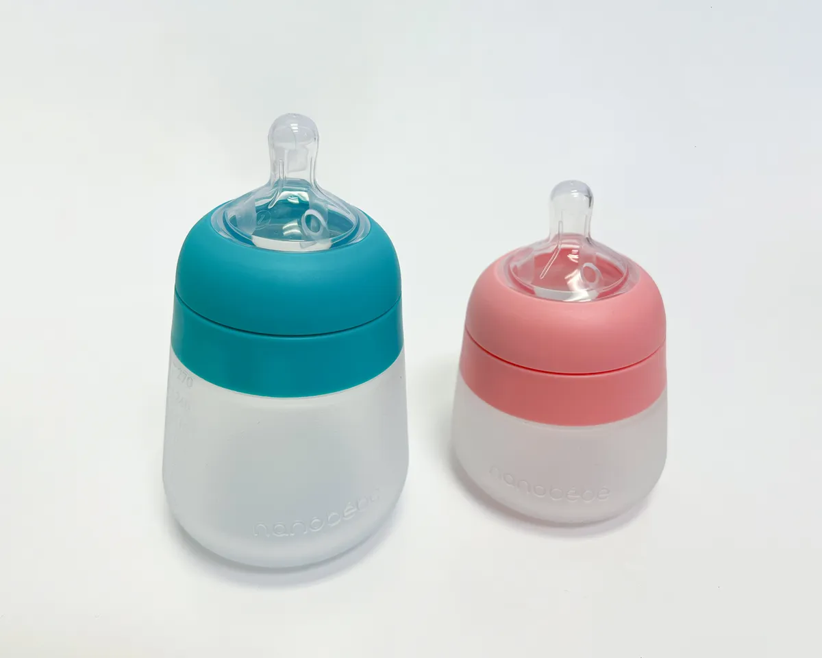 Silicone baby bottle parts laid out for washing, representative of the daily cleaning routine formula-feeding equipment requires