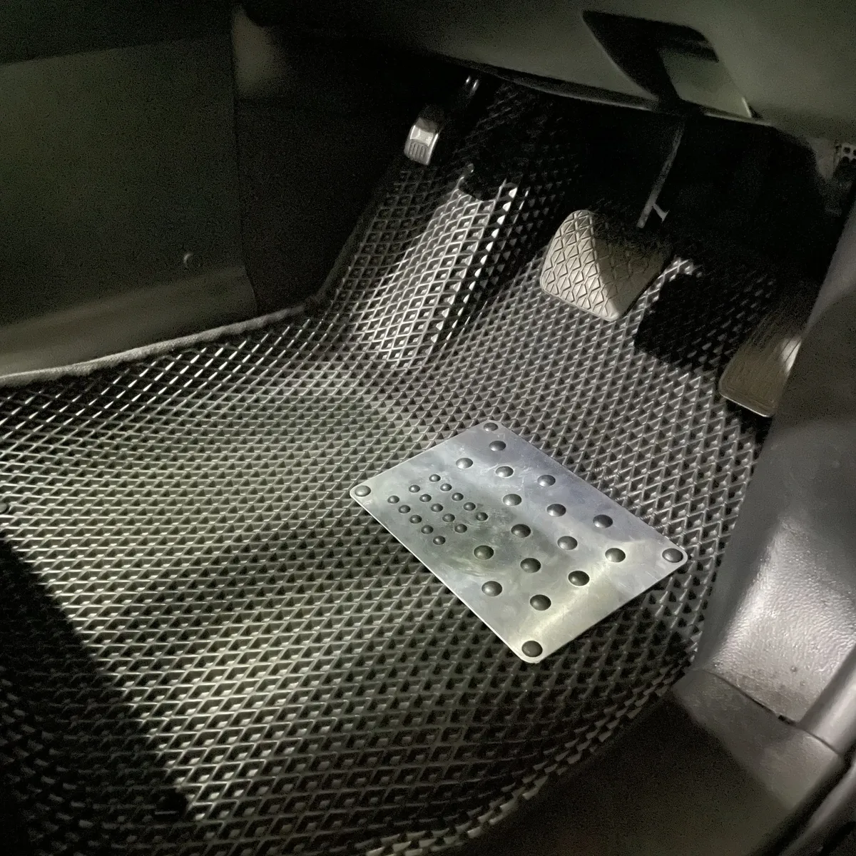 Molded all-weather car floor mat with raised channel edges designed to contain liquid and debris