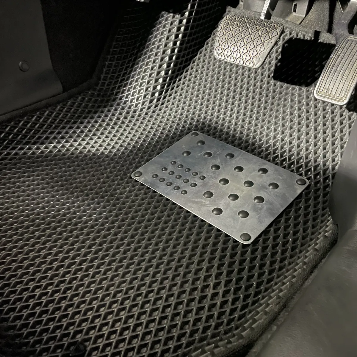 Set of custom-molded all-weather floor mats for front and rear footwells, shown removed from a vehicle