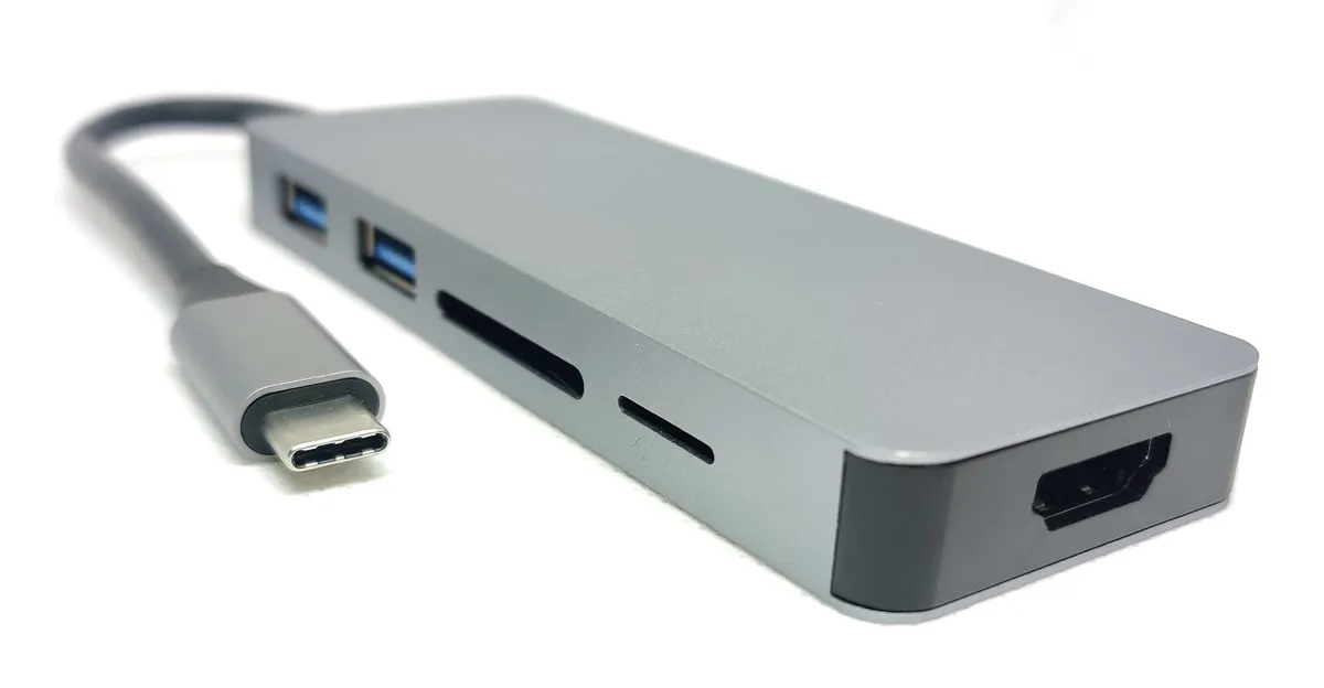 A compact multiport USB-C hub with several ports including USB-A and card slots