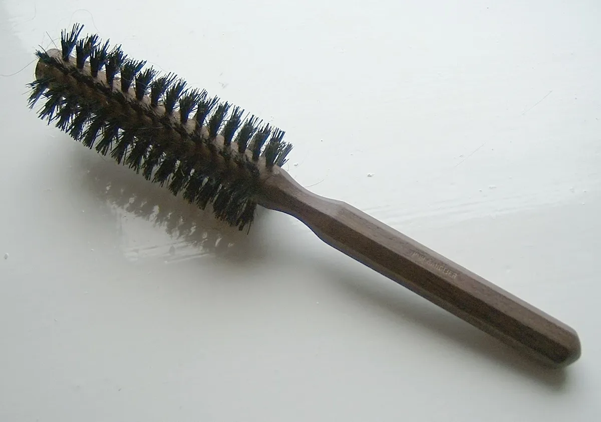 A round hairbrush with mixed bristles, similar in bristle style to the brush barrel used on hot-air styling brushes