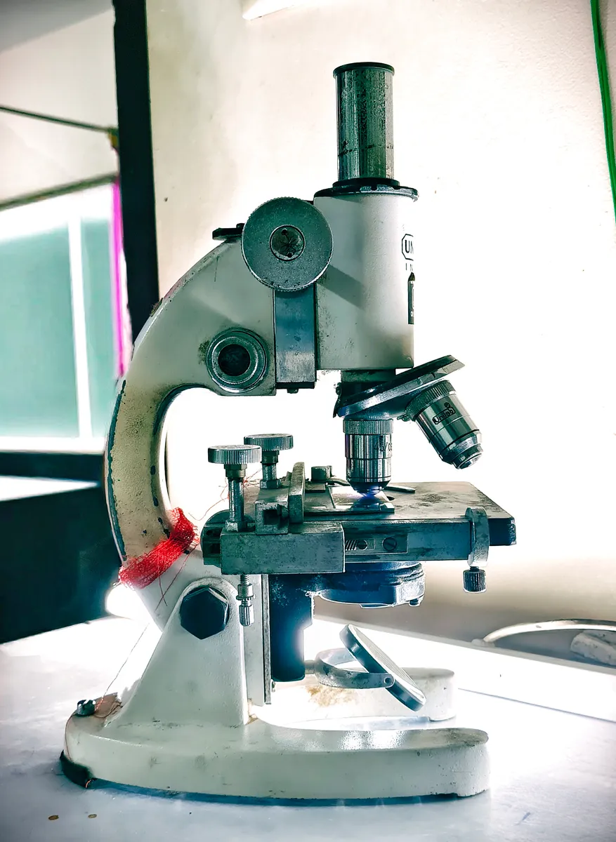 A laboratory optical microscope of the type that improves on student models with a geared stage