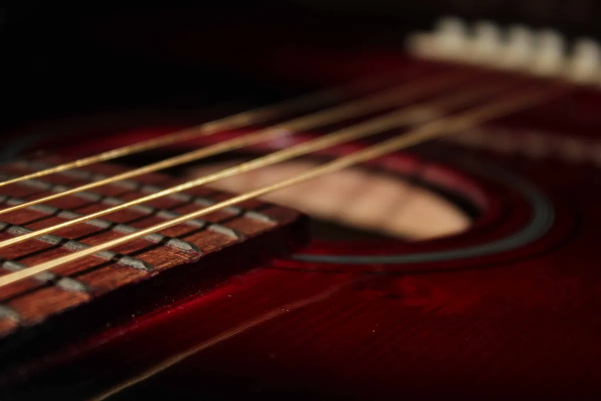 Close-up of an acoustic guitar top, bridge and strings